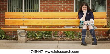 Stock Photo - Student sitting alone. Fotosearch
