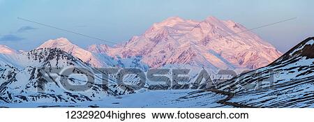 Stock Photograph - Sunrise Lights Upper Slopes Of Denali Seen From Stony Dome On The Denali National Park Road, Mckinley Village; Alaska, United States Of America. Fotosearch