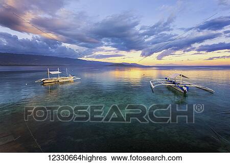 Sunset Over The Ocean With Pump Boats; Moalboal, Cebu, Central Visayas, Philippines View Large Photo Image Stock Photograph - Sunset Over The Ocean With Pump Boats; Moalboal, Cebu, Central Visayas, Philippines. Fotosearch