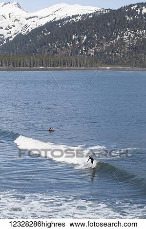 Surfer And Kayaker In The Waters Of The Kenai Peninsula Outer Coast, Southcentral Alaska, USA View Large Photo Image Stock Photograph - Surfer And Kayaker In The Waters Of The Kenai Peninsula Outer Coast, Southcentral Alaska, USA. Fotosearch
