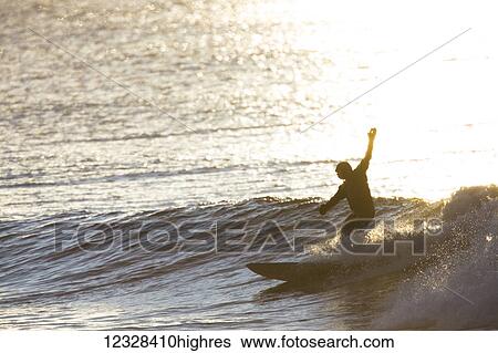 Stock Photograph - Surfer Catching A Wave In Kachemak Bay Near Homer, Southcentral Alaska, USA. Fotosearch