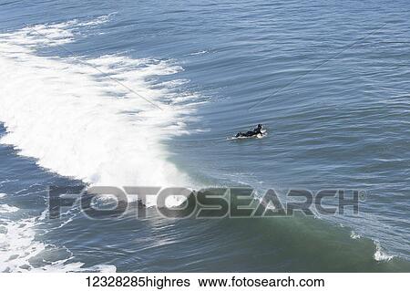 Surfer Enters The Waters Of The Kenai Peninsula Outer Coast, Southcentral Alaska, USA View Large Photo Image Stock Photograph - Surfer Enters The Waters Of The Kenai Peninsula Outer Coast, Southcentral Alaska, USA. Fotosearch