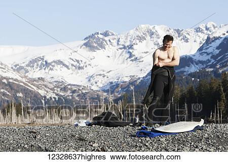 Surfer gearing up to go surfing on the Kenai Peninsula Outer Coast, South-central Alaska; Alaska, United States of America View Large Photo Image Stock Photograph - Surfer gearing up to go surfing on the Kenai Peninsula Outer Coast, South-central Alaska; Alaska, United States of America. Fotosearch