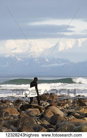 Surfer On The Beach Near Yakutat, Southeast Alaska, USA View Large Photo Image Stock Photograph - Surfer On The Beach Near Yakutat, Southeast Alaska, USA. Fotosearch