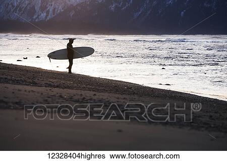 Stock Photograph - Surfer On The Shores Of Kachemak Bay, Homer Spit, Southcentral Alaska, USA. Fotosearch