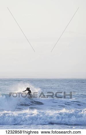 Surfer riding waves near Yakutat, Southeast Alaska; Alaska, United States of America View Large Photo Image Stock Photograph - Surfer riding waves near Yakutat, Southeast Alaska; Alaska, United States of America. Fotosearch