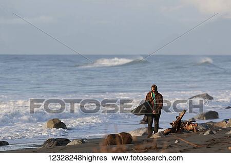 Surfer Walking With A Surfboard Along The Coast Near Yakutat, Southeast Alaska, USA View Large Photo Image Stock Photograph - Surfer Walking With A Surfboard Along The Coast Near Yakutat, Southeast Alaska, USA. Fotosearch