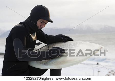 Surfer Waxing A Surfboard In Winter Along Kachemak Bay, Homer Spit, Southcentral Alaska, USA View Large Photo Image Stock Photograph - Surfer Waxing A Surfboard In Winter Along Kachemak Bay, Homer Spit, Southcentral Alaska, USA. Fotosearch