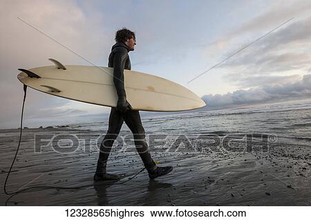 Surfer with board at sunset, Southeast Alaska; Yakutat, Alaska, United States of America View Large Photo Image Stock Photograph - Surfer with board at sunset, Southeast Alaska; Yakutat, Alaska, United States of America. Fotosearch