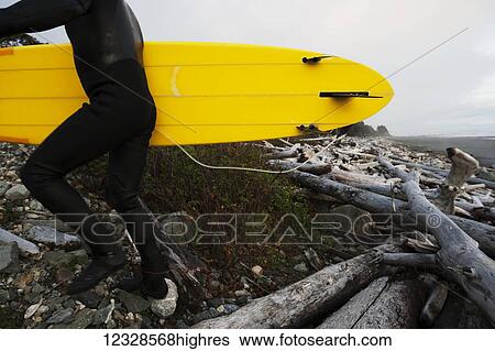 Surfer with board on driftwood beach, Southeast Alaska; Yakutat, Alaska, United States of America View Large Photo Image Stock Photograph - Surfer with board on driftwood beach, Southeast Alaska; Yakutat, Alaska, United States of America. Fotosearch