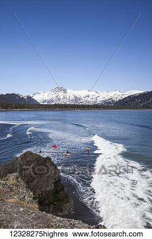 Surfers Along The Kenai Peninsula Outer Coast, Southcentral Alaska, USA View Large Photo Image Stock Photograph - Surfers Along The Kenai Peninsula Outer Coast, Southcentral Alaska, USA. Fotosearch