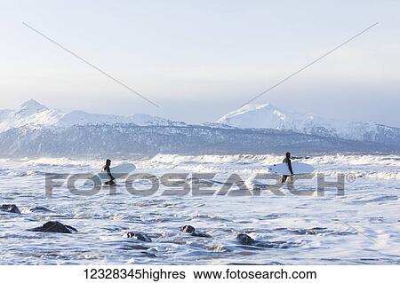 Stock Photograph - Surfers Entering Kachemak Bay Along Homer Spit, Southcentral Alaska, USA. Fotosearch