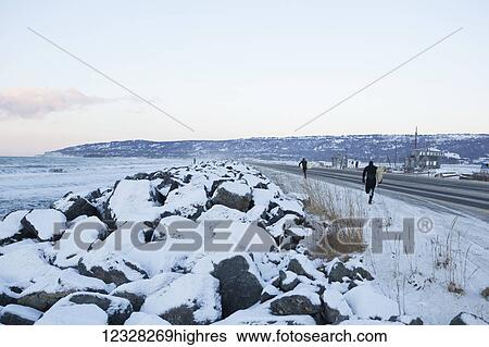 Surfers Walking Along Homer Spit In Winter, Kenai Peninsula, Southcentral Alaska, USA View Large Photo Image Stock Photograph - Surfers Walking Along Homer Spit In Winter, Kenai Peninsula, Southcentral Alaska, USA. Fotosearch