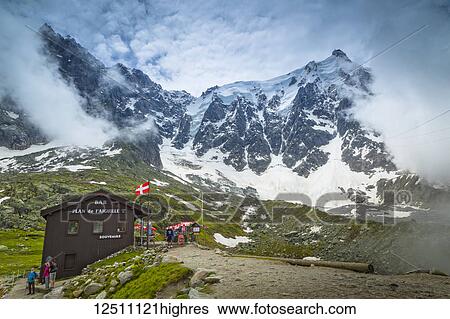The chalet at Plan de l'Aiguille and Aiguille du Midi summit in the fog; Chamonix-Mont-Blanc, Haute-Savoie, France View Large Photo Image Stock Photograph - The chalet at Plan de l'Aiguille and Aiguille du Midi summit in the fog; Chamonix-Mont-Blanc, Haute-Savoie, France. Fotosearch