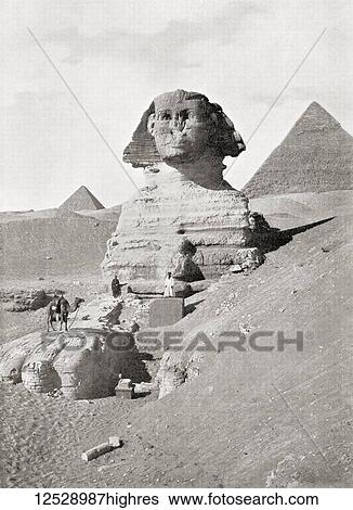 Stock Photograph - The Great Sphinx in The Giza pyramid complex, Giza Plateau, Cairo, Egypt. A massive sculpture generally believed to represent the Pharaoh Khafre. Seen here are workers clearing away sand which chokes the base of the monument. From The Wonders of.... Fotosearch