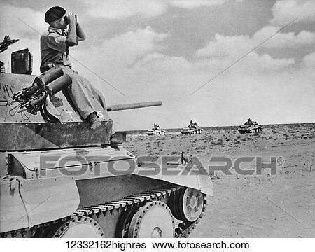 Stock Photograph - The Illustrated London News 1941. World war II. British Commander of a light calavary tank keeping a look out as his unit advances.. Fotosearch