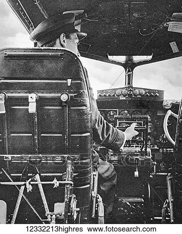 Stock Photograph - The Illustrated London News 1941. World war II. R. A. F pilot at the controls of a Flying Fortress. Fotosearch