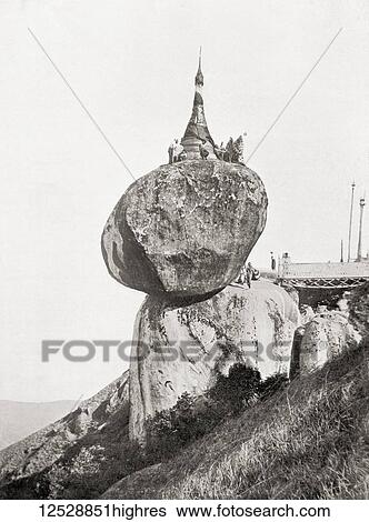 Stock Photograph - The Kyaiktiyo Pagoda, Mon State, Burma. A small pagoda built on the top of a granite boulder. From The Wonders of the World, published c. 1920.. Fotosearch