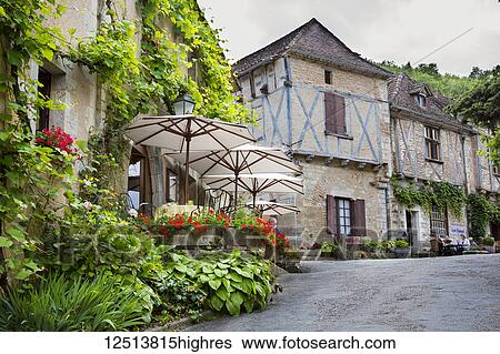 The narrow cobbled streets of St Cirq Lapopie contain a lovely mixture of medieval houses, some in half-timbered and some in the local yellow stone, with small terraced gardens adding to the overall beauty of the place. Many of the houses date from... View Large Photo Image Stock Photograph - The narrow cobbled streets of St Cirq Lapopie contain a lovely mixture of medieval houses, some in half-timbered and some in the local yellow stone, with small terraced gardens adding to the overall beauty of the place. Many of the houses date from.... Fotosearch