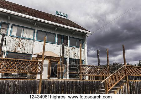 Stock Photograph - The Paxson Lodge sits shuttered along the Richardson Highway after closing in 2013; Alaska, United States of America. Fotosearch