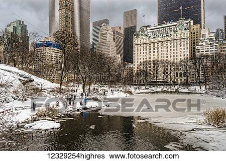 Stock Photograph - The Pond Partially Frozen After A Snowstorm, In Central Park; New York City, New York, United States Of America. Fotosearch