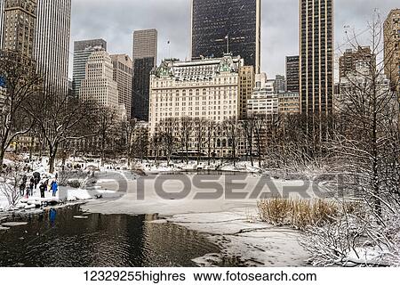 Stock Photograph - The Pond Partially Frozen After A Snowstorm, In Central Park; New York City, New York, United States Of America. Fotosearch