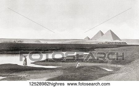 Stock Photograph - The pyramids of Giza, Giza Plateau, Cairo, Egypt. The Great Pyramid of Giza aka the Pyramid of Cheops or Khufu, Pyramid of Khafre aka Chephren and the Pyramid of Menkaure aka Mykerinos. From The Wonders of the World, published c. 1920.. Fotosearch