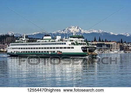 Stock Photograph - The Washington State Ferry Walla Walla departs Bremerton, Washington. 'The Brothers' comminate in the distance, part of the Olympic Mountain Range; Bremerton, Washington, United States of America. Fotosearch