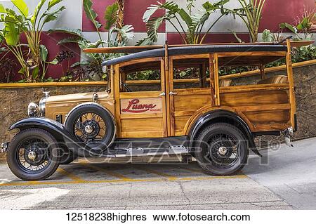 Stock Photograph - This 1930 Ford Model A Woody classic car is on display at the Luana Hotel, Waikiki, Honolulu, Oahu, Hawaii, United States of America. Fotosearch