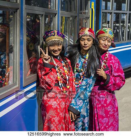 Three women wearing kimonos pose outside the Darjeeling Toy Train, Darjeeling Himalayan Railway; Darjeeling, West Bengal, India View Large Photo Image Stock Photograph - Three women wearing kimonos pose outside the Darjeeling Toy Train, Darjeeling Himalayan Railway; Darjeeling, West Bengal, India. Fotosearch