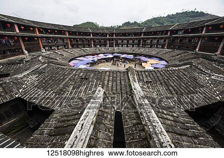Stock Photograph - Tiled roofs around the circular common inner courtyard in the Eryi Building, Dadi Tulou; Fujian, China. Fotosearch