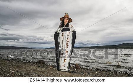 Stock Photograph - Tlingit first nation woman in traditional wardrobe on the shores of Teslin Lake; Teslin, Yukon, Canada. Fotosearch