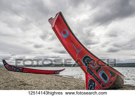 Stock Photograph - Tlingit long canoes on the shore of Teslin Lake; Teslin, Yukon, Canada. Fotosearch