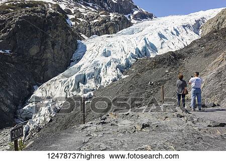 Tourist photographs receding Exit Glacier in Kenai Fjords National Park near Seward; Alaska, United States of America View Large Photo Image Stock Photograph - Tourist photographs receding Exit Glacier in Kenai Fjords National Park near Seward; Alaska, United States of America. Fotosearch