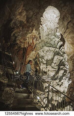 Stock Photograph - Tourist views stalagmites in an underground cave; Italy. Fotosearch