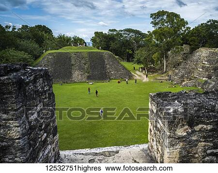 Stock Photograph - Tourists at the ruins in a Mayan village; San Jose Succotz, Cayo District, Belize. Fotosearch