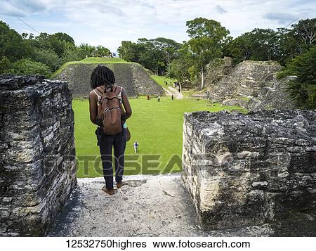 Stock Photograph - Tourists at the ruins of a Mayan village; San Jose Succotz, Cayo District, Belize. Fotosearch