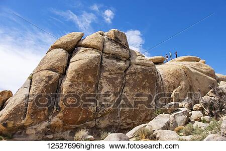 Tourists climbing on large boulders in Joshua Tree National Park; California, United States of America View Large Photo Image Stock Photograph - Tourists climbing on large boulders in Joshua Tree National Park; California, United States of America. Fotosearch