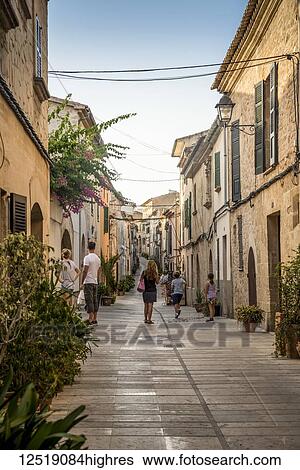 Tourists in one of Alcudia's narrow streets; Alcudia, Mallorca, Balearic Islands, Spain View Large Photo Image Stock Photograph - Tourists in one of Alcudia's narrow streets; Alcudia, Mallorca, Balearic Islands, Spain. Fotosearch