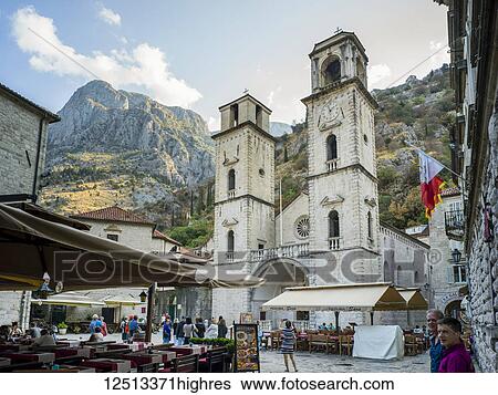 Tourists in the streets of Kotor with outdoor restaurant patios and a church building with two towers; Kotor, Kotor Municipality, Monte View Large Photo Image Stock Photograph - Tourists in the streets of Kotor with outdoor restaurant patios and a church building with two towers; Kotor, Kotor Municipality, Monte. Fotosearch