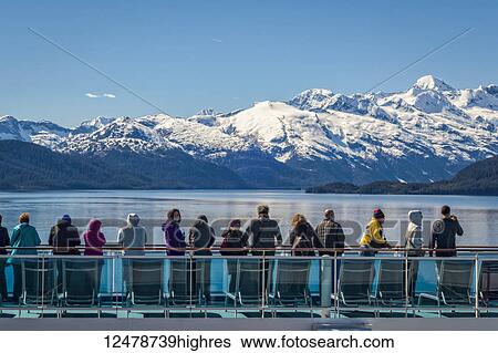 Stock Photograph - Tourists on cruise ship in College Fjord in Glacier Bay National Park and Preserve; Alaska, United States of America. Fotosearch