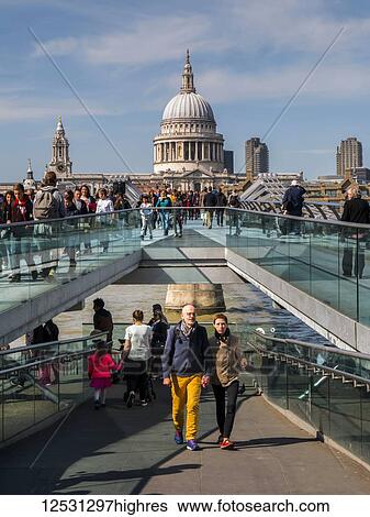 Tourists on Millennium Bridge with St. Paul's Cathedral in the background; London, England View Large Photo Image Stock Photograph - Tourists on Millennium Bridge with St. Paul's Cathedral in the background; London, England. Fotosearch