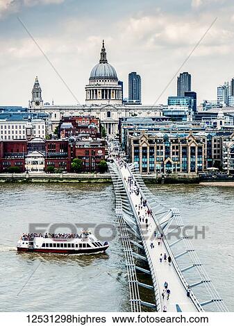 Tourists on Millennium Bridge with St. Paul's Cathedral in the background, viewed from Tate Switch; London, England View Large Photo Image Stock Photograph - Tourists on Millennium Bridge with St. Paul's Cathedral in the background, viewed from Tate Switch; London, England. Fotosearch