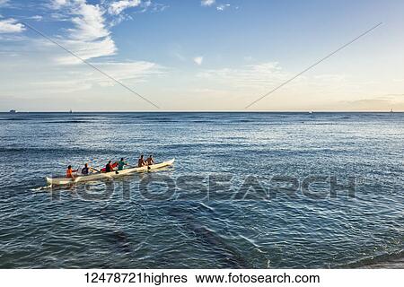 Tourists paddle in an outrigger canoe off Waikiki Beach; Waikiki, Oahu, Hawaii, United States of America View Large Photo Image Stock Photograph - Tourists paddle in an outrigger canoe off Waikiki Beach; Waikiki, Oahu, Hawaii, United States of America. Fotosearch
