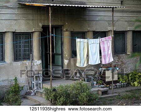 Towels hanging on a clothesline to dry outside a residential building; Kostol, Mehedin? i County, Serbia View Large Photo Image Stock Photograph - Towels hanging on a clothesline to dry outside a residential building; Kostol, Mehedin? i County, Serbia. Fotosearch