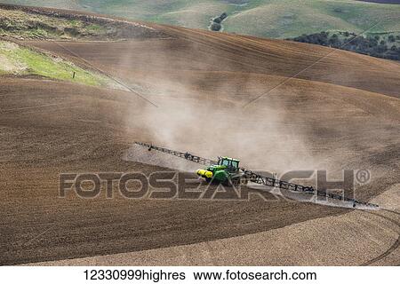 Track Tractor Configured With Spraying Booms Spraying Fertilizer On A Garbonzo Bean Seedbed In The Palouse Region Of Eastern Washington; Washington, United States Of America View Large Photo Image Stock Photograph - Track Tractor Configured With Spraying Booms Spraying Fertilizer On A Garbonzo Bean Seedbed In The Palouse Region Of Eastern Washington; Washington, United States Of America. Fotosearch