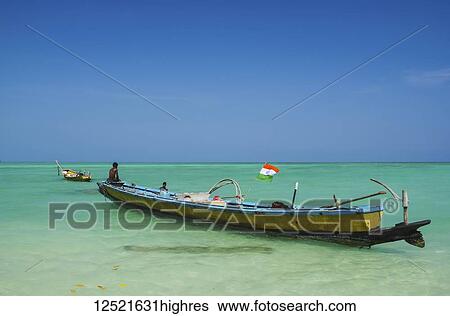 Traditional fishing boat in the turquoise waters; Andaman Islands, India View Large Photo Image Stock Photograph - Traditional fishing boat in the turquoise waters; Andaman Islands, India. Fotosearch