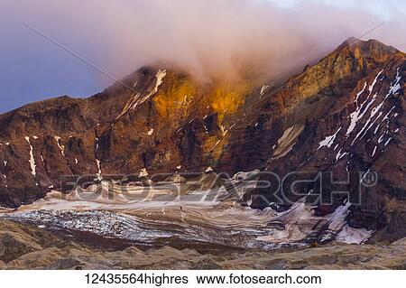 Trident Volcano rises above the ash-covered Knife Creek Glaciers at sunset in Katmai National Park; Alaska, United States of America View Large Photo Image Stock Photograph - Trident Volcano rises above the ash-covered Knife Creek Glaciers at sunset in Katmai National Park; Alaska, United States of America. Fotosearch