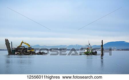 Tugboat pulling barge with construction equipment, Blackie Spit, Crescent Beach; Surrey, British Columbia, Canada View Large Photo Image Stock Photograph - Tugboat pulling barge with construction equipment, Blackie Spit, Crescent Beach; Surrey, British Columbia, Canada. Fotosearch