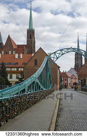 Tumski Bridge And Lovers Locks With Spires Of Cathedral In The Background; Wroclaw, Lower Silesia, Poland View Large Photo Image Stock Photograph - Tumski Bridge And Lovers Locks With Spires Of Cathedral In The Background; Wroclaw, Lower Silesia, Poland. Fotosearch
